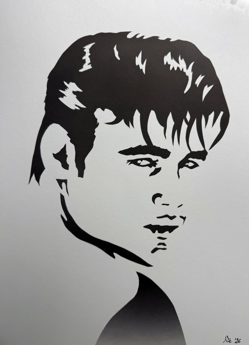 Hand-cut paper silhouette portrait, black on white.