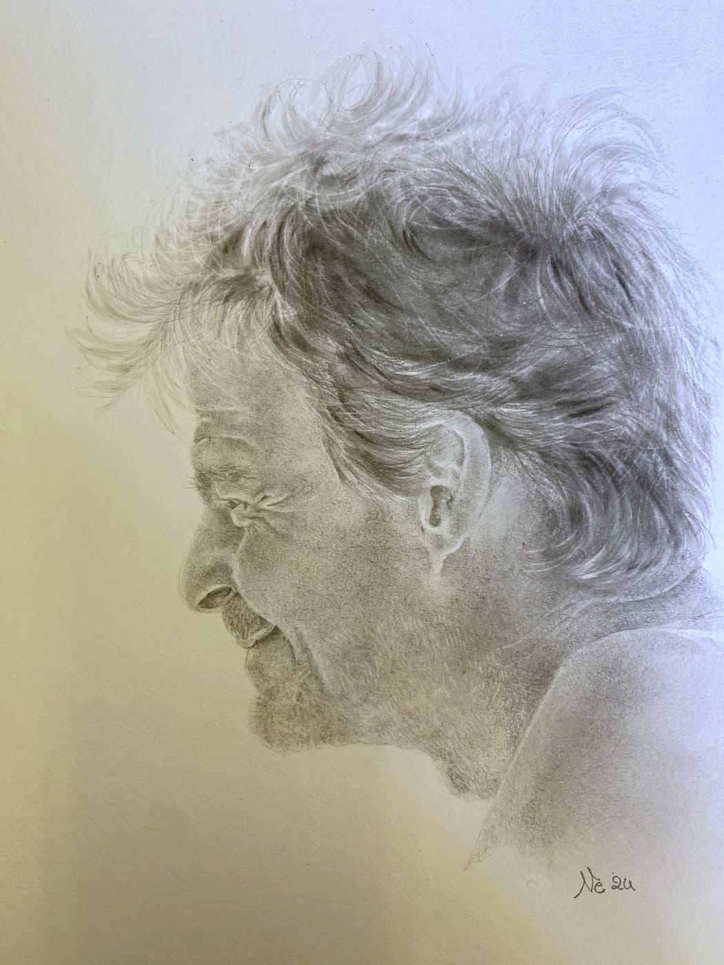 Pencil profile portrait of an older man with tousled hair, laughing.