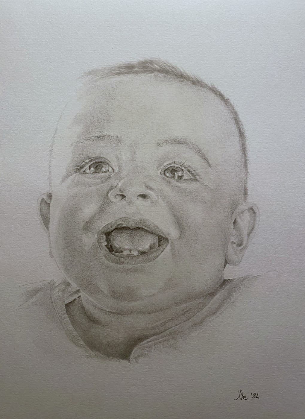 Pencil portrait of a laughing baby.